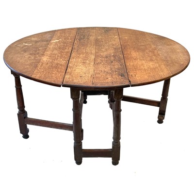 Lot 152 - An oak gateleg dining table.