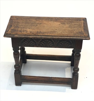 Lot 3322 - An oak joint stool, the carved frieze on...