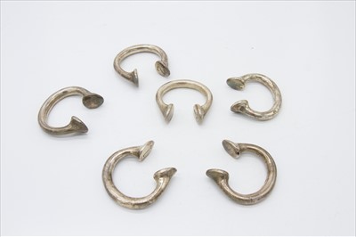 Lot 2303 - A set of six silver plated slave bangle napkin...