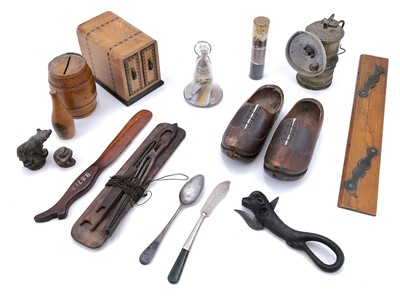 Lot 64 - A 19th century glass vial displaying cassiterite at different stages of processing.