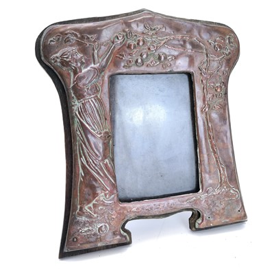 Lot 60 - An Art Nouveau copper picture frame with repousse decoration of a maiden picking apples.