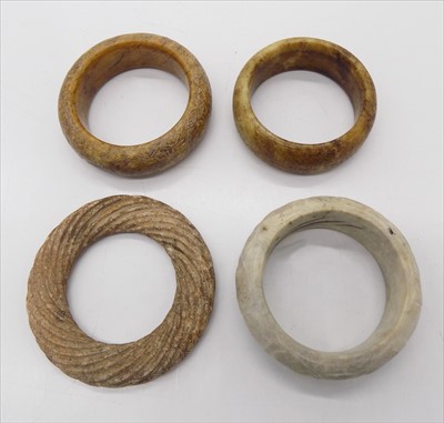 Lot 1161 - Four Chinese hardstone bangles.