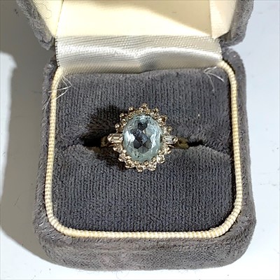 Lot 2492 - An 18ct gold ring set an aquamarine surrounded...