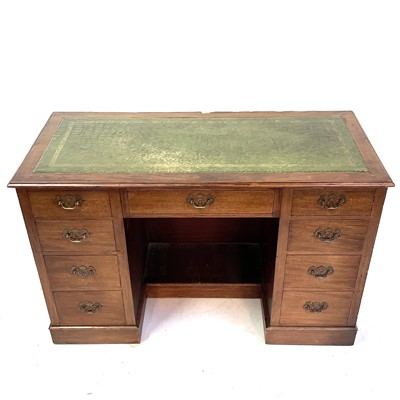 Lot 1890 - An Edwardian walnut kneehole desk.