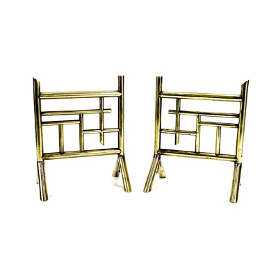 Lot 51 - A pair of Benham and Froud Aesthetic movement brass firedogs, probably Christopher Dresser.