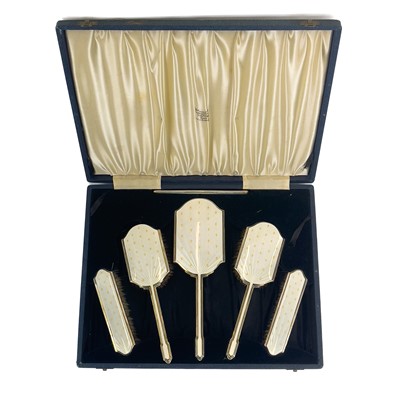 Lot 110 - A George VI silver and enamel dressing table set, cased.
