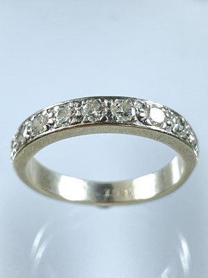 Lot 119 - An 18ct white gold diamond set nine stone half eternity ring.