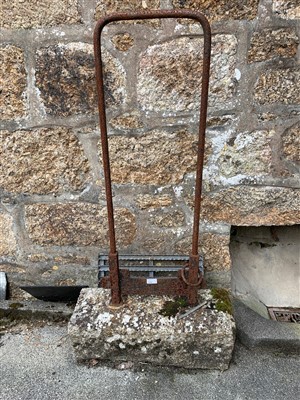 Lot 67 - An iron horse tether/ boot scraper set in a...
