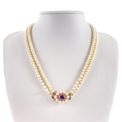 Lot 24 - A 1960's cultured pearl graduated double row necklace with 9ct amethyst set clasp.