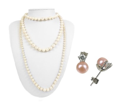 Lot 93 - A 1950's white gold and diamond set graduated cultured pearl necklace.
