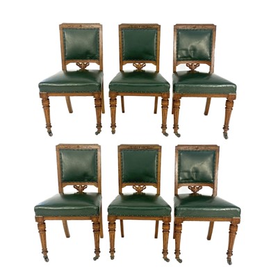 Lot 1929 - A set of six Victorian oak and leather library chairs.
