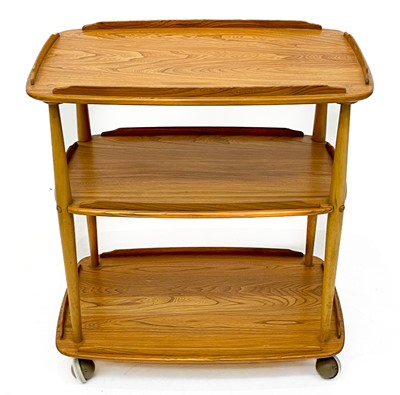 Lot 1852 - An Ercol Windsor light elm three tier trolley with lipped edges.