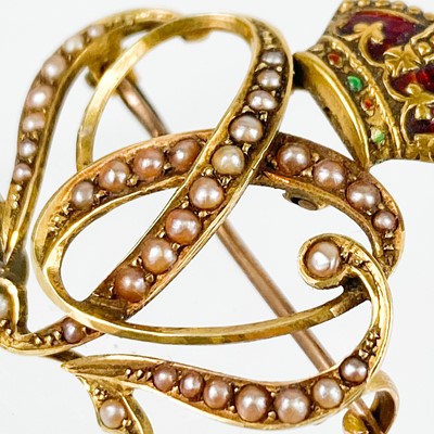 Lot 73 - An Edwardian high purity gold, enamel and seed pearl set '1902' coronation brooch.