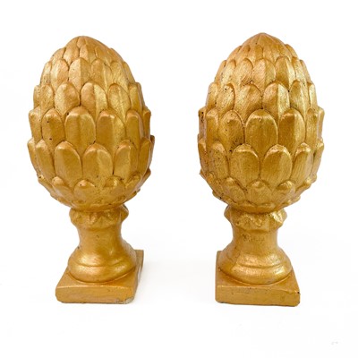 Lot 607 - Pair of stone acorns painted gold.