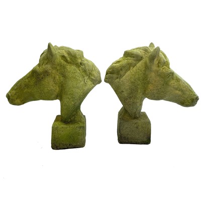 Lot 602 - A pair of reconstituted stone models of horse heads.