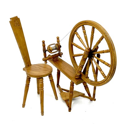 Lot 89 - An oak spinning wheel and chair.