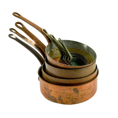 Lot 66 - A set of nine graduating copper pans.