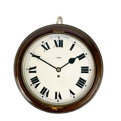 Lot 1715 - An oak circular wall clock.