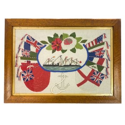 Lot 441 - A 20th century sailor's woolwork picture decorated with flags, ships and anchor.