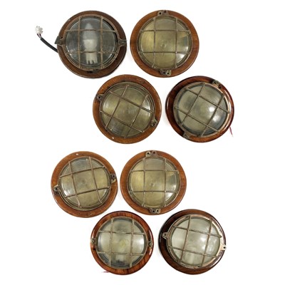 Lot 479 - A collection of eight bulkhead lights.