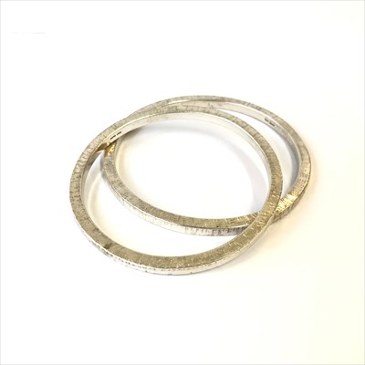 Lot 2679 - Two heavy sterling silver bangles by John...