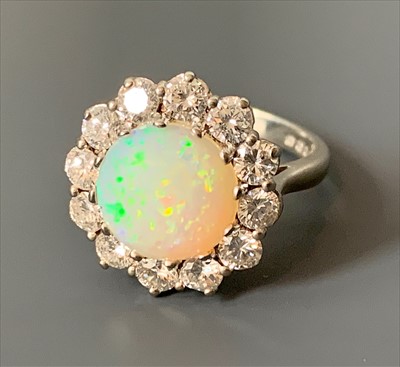 Lot 2507 - An 18ct white gold diamond and opal ring. Opal...
