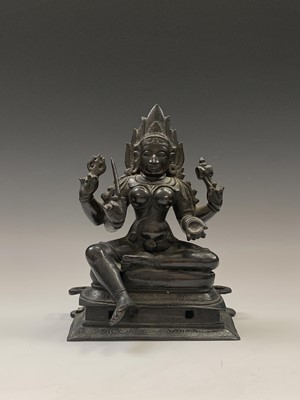 Lot 372 - An Indian bronze figure of a seated goddess,...