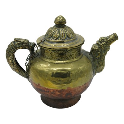 Lot 1180 - A Tibetan brass and copper large teapot, 19th...