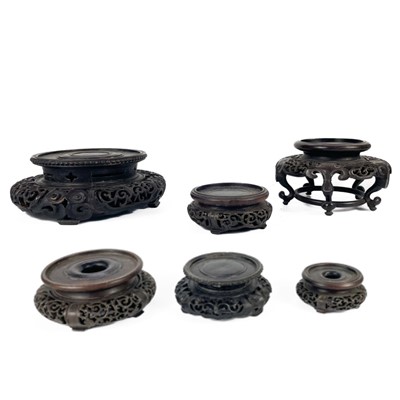 Lot 57 - Six Chinese carved hardwood vase stands, 19th century.
