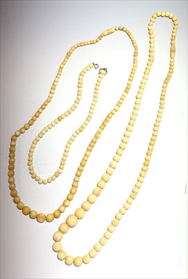 Lot 2548 - Two ivory necklaces and a bone necklace