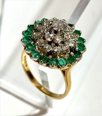 Lot 2511 - An 18ct gold emerald and diamond flowerhead...