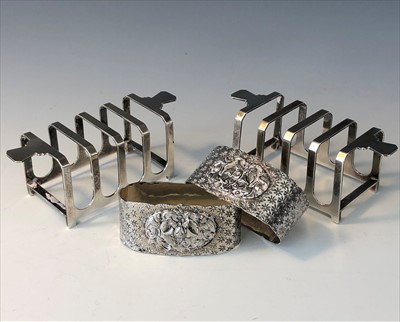 Lot 2055 - A pair of small silver Art Deco toast racks...