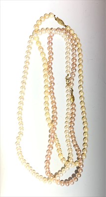 Lot 2426 - Three cultured pearl necklaces each with a...