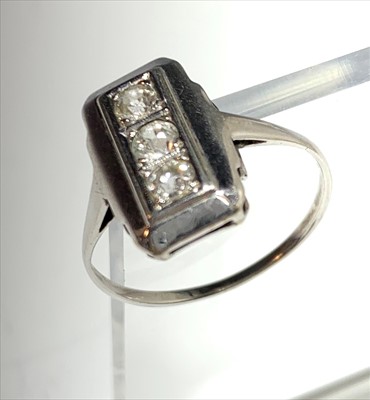 Lot 2429 - A 18ct white gold three stone diamond Art Deco...