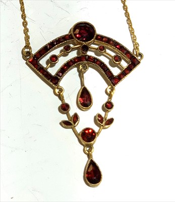 Lot 2427 - An Art Nouveau gold red stone set necklace.