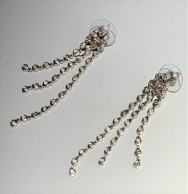 Lot 2453 - A pair of diamond set fall earrings.