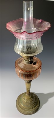 Lot 329 - A Victorian oil lamp, with red tinted font,...