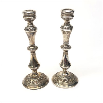 Lot 2059 - A pair of filled silver candle sticks with...