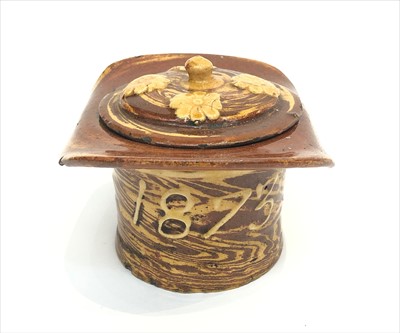 Lot 355 - A 19th century treacle glaze tobacco jar in...