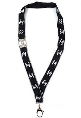 Lot 565 - A Chanel white tone metal and crystal set CC lanyard.