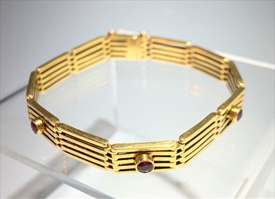 Lot 2476 - An 18ct gold gatelink bracelet set five rubies,...