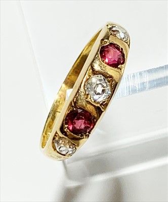 Lot 2588 - An 18ct gold five stone diamond and ruby ring,...