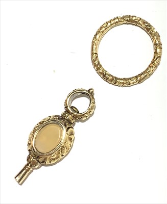 Lot 2578 - A gold watch key and a gold split ring.