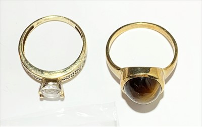 Lot 2580 - Two gold rings, one set with tigers eye.