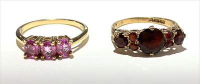 Lot 2581 - A ring set red stones and another set pink...