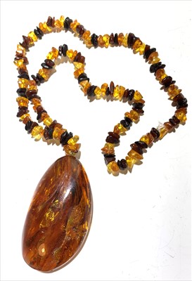 Lot 2626 - An amber chip necklace with a large amber drop...