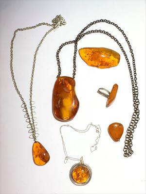 Lot 2599 - Three amber necklaces, the largest pendant 6.9...
