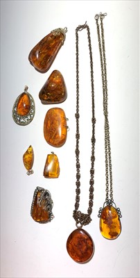 Lot 2616 - Two amber necklaces, five amber pendants,...