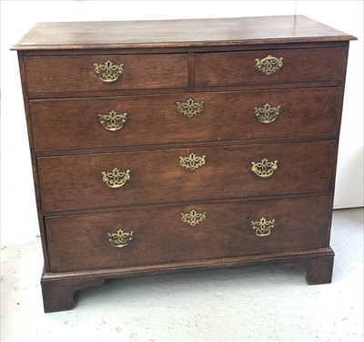 Lot 3298 - A George III oak chest of drawers, with two...