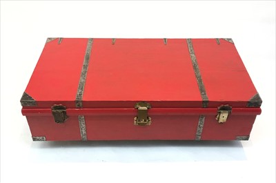 Lot 3301 - A red painted wooden trunk, the brass lock...